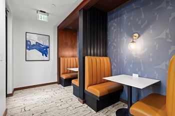 A restaurant interior with a blue wallpaper and a white table.