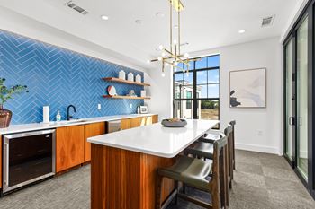 A kitchen with a blue tile backsplash and wooden cabinets.