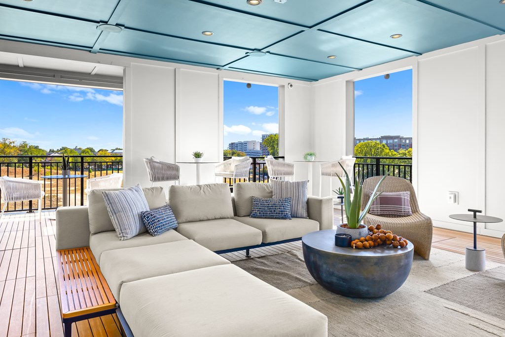 A modern living room with a large sofa set and a wooden bench.