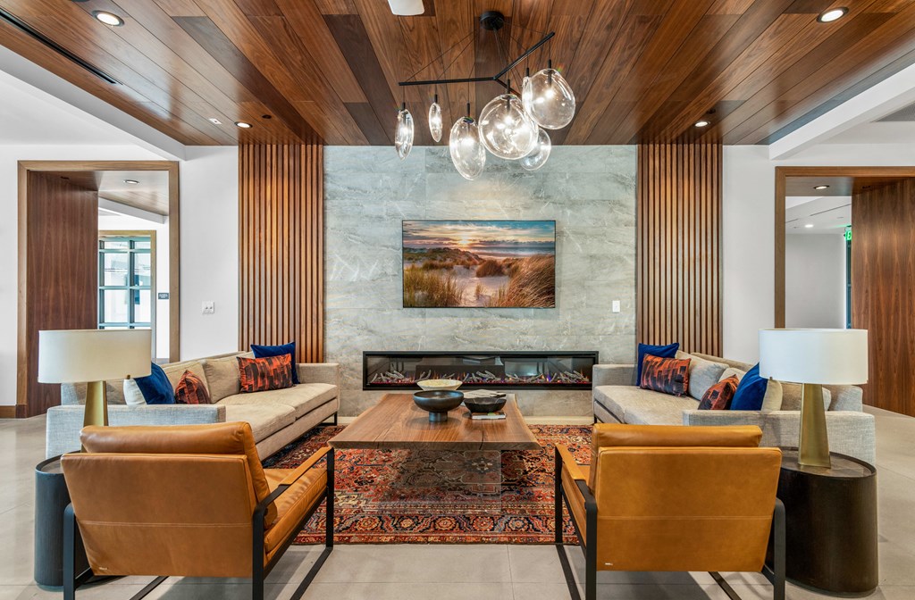 a living room with couches and chairs and a fireplace at The Colony, Charlotte, NC