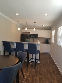 A kitchen with a table and chairs.