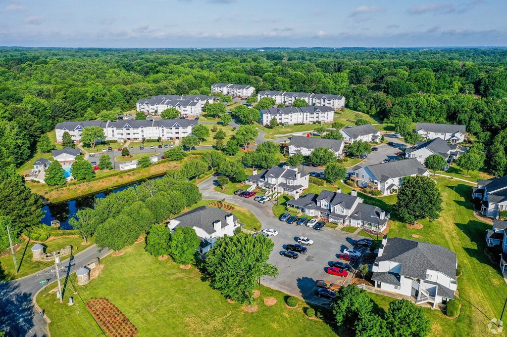 A bird's eye view of a residential area with houses and a river.