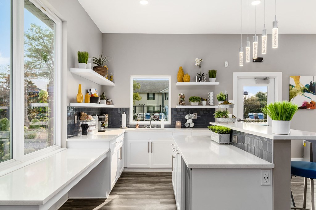 A modern kitchen with white countertops and a large island at Estates at Brentwood Lake Apartments, Ohio