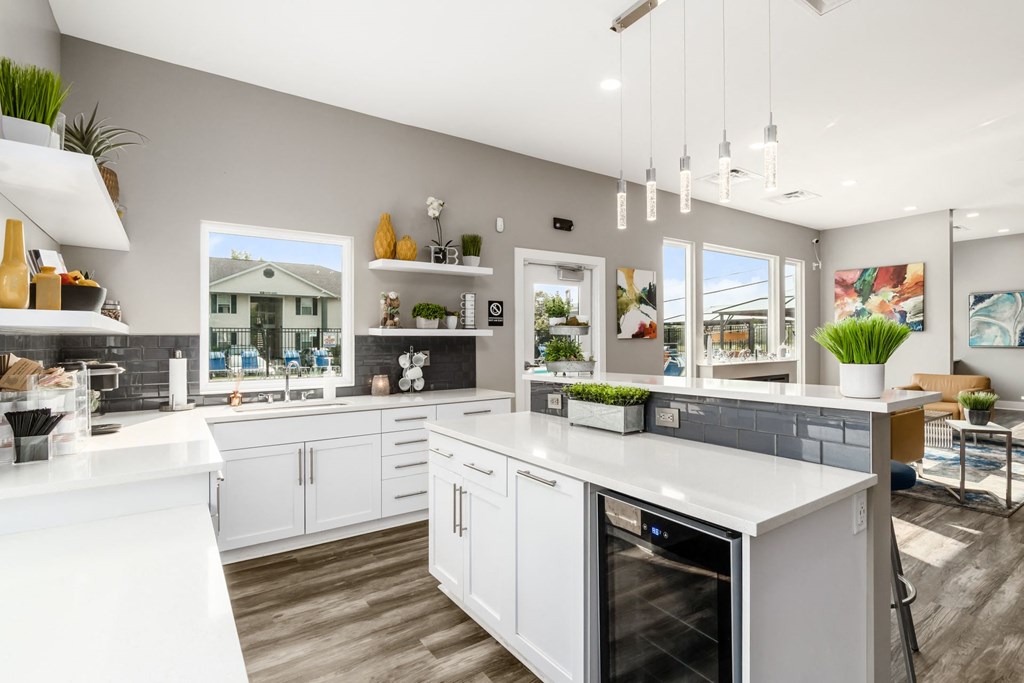 A modern kitchen with white cabinets and a large island at Estates at Brentwood Lake Apartments, Reynoldsburg
