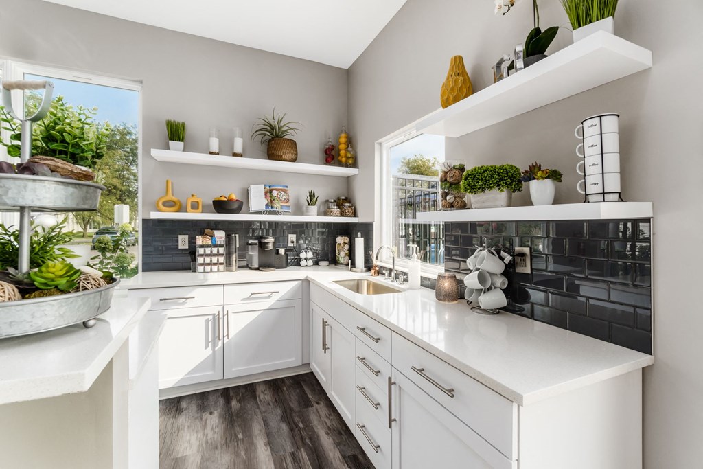 A kitchen with white cabinets and a large island with plants on it at Estates at Brentwood Lake Apartments, Reynoldsburg, 43068