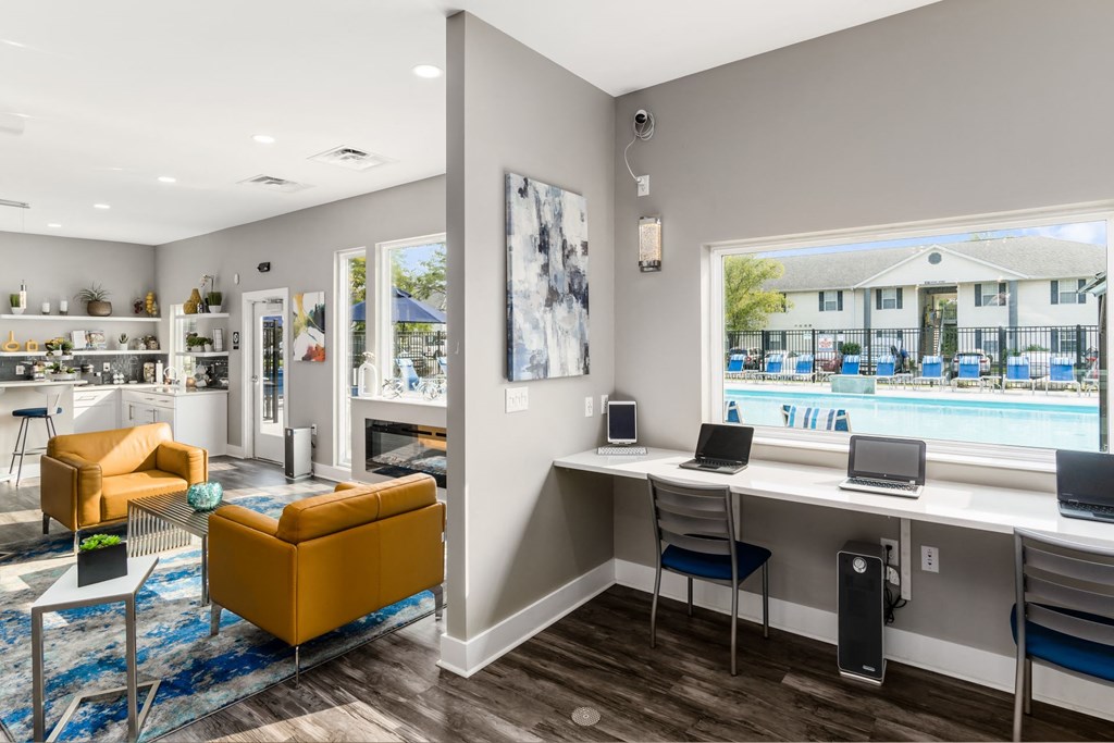A room with a yellow chair and a desk with a laptop on it at Estates at Brentwood Lake Apartments, Reynoldsburg, Ohio