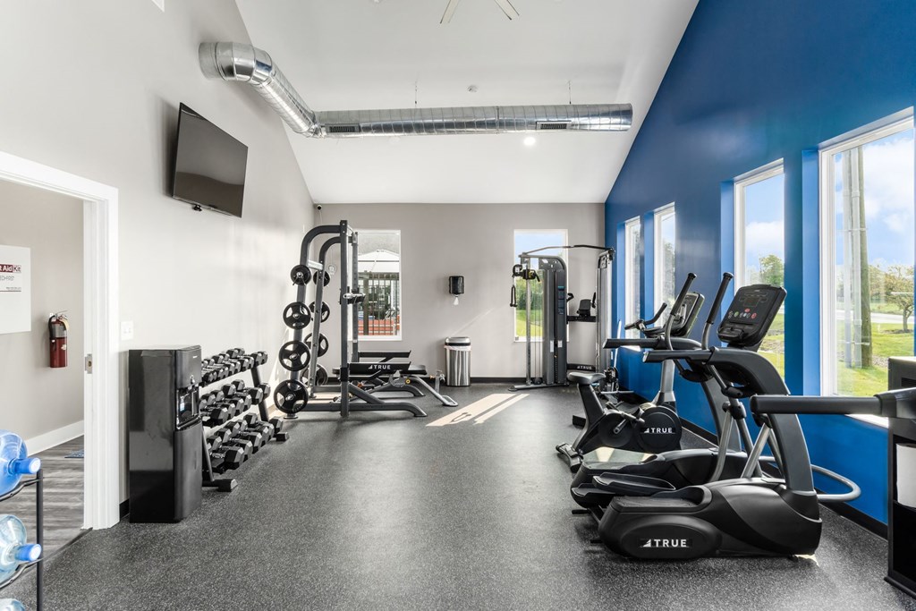 A gym with a variety of equipment including treadmills, weights, and exercise machines at Estates at Brentwood Lake Apartments, Ohio, 43068
