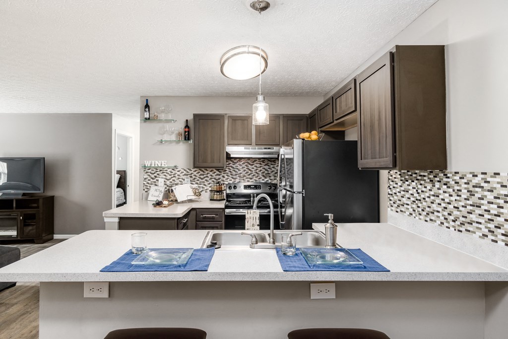 A kitchen with a white countertop and a black refrigerator at Estates at Brentwood Lake Apartments, Reynoldsburg, Ohio