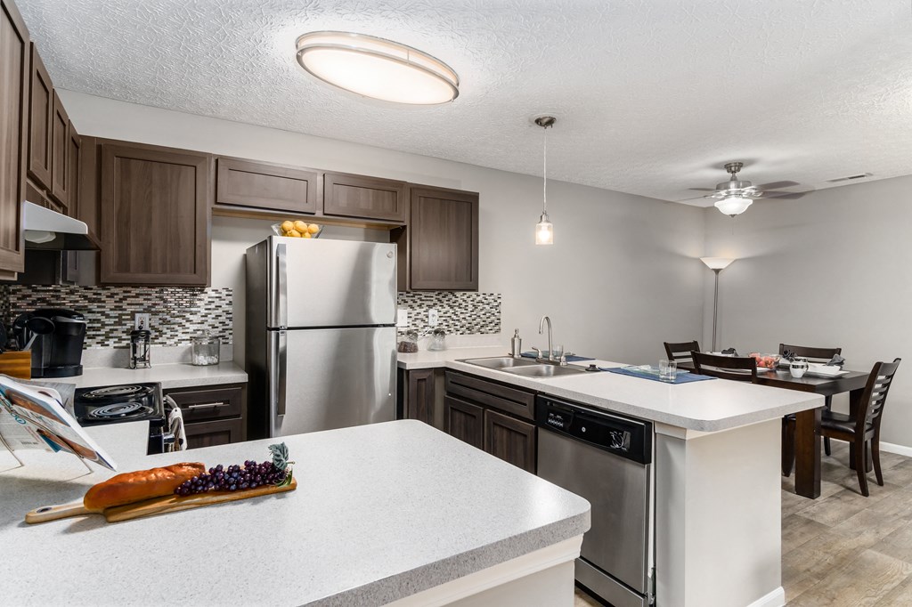 A kitchen with a white counter top and a refrigerator at Estates at Brentwood Lake Apartments, Reynoldsburg, OH