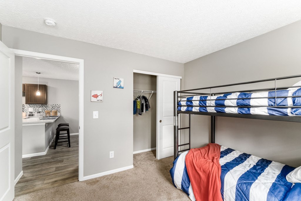 A bedroom with a bunk bed and a desk at Estates at Brentwood Lake Apartments, Reynoldsburg, OH