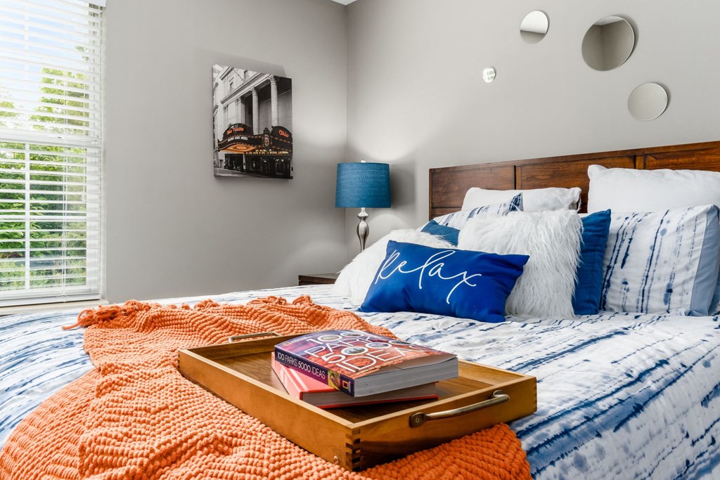 A bed with a tray of books on it at Estates at Brentwood Lake Apartments, Reynoldsburg
