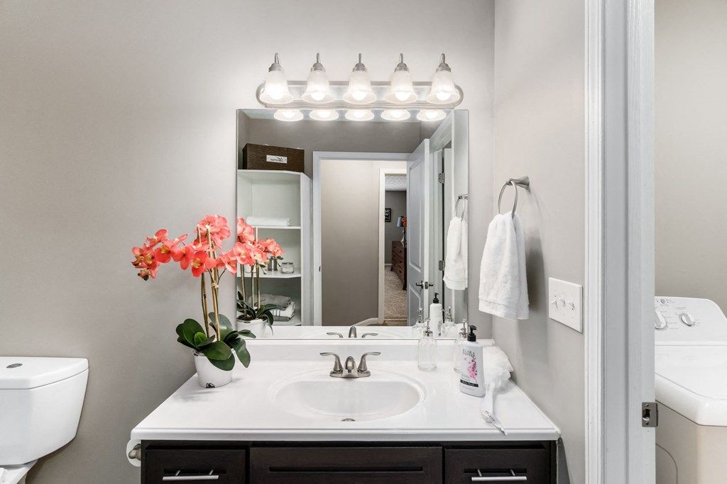 A bathroom with a white sink and a mirror above it at Estates at Brentwood Lake Apartments, Reynoldsburg, Ohio