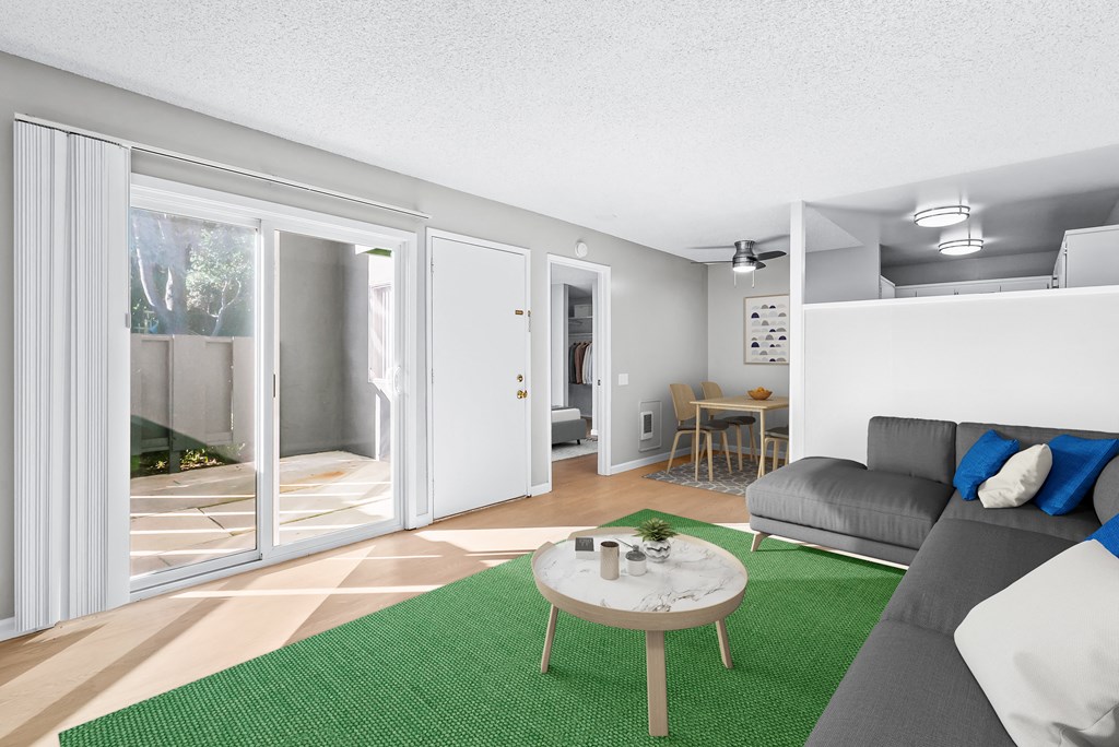 a living room with a green rug and a couch