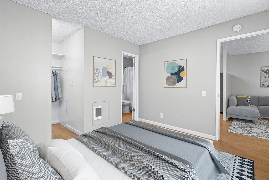 a bedroom with a large bed and a mirror