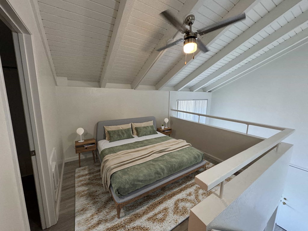 a bedroom with a bed and a ceiling fan