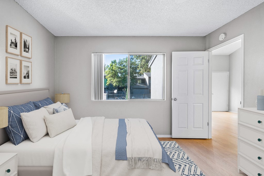 a bedroom with a bed and a window