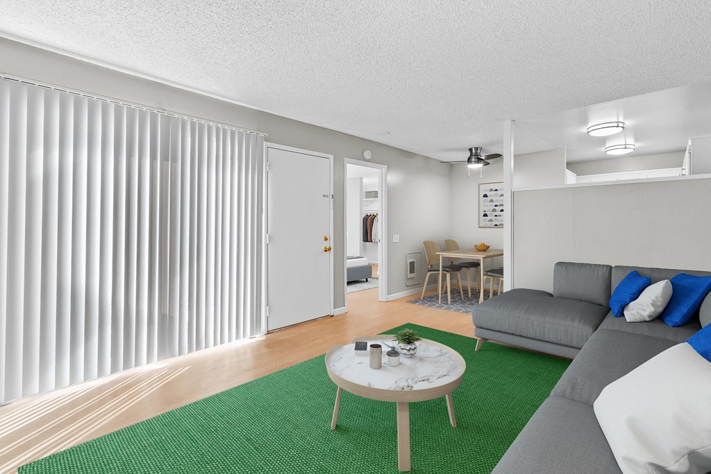 a living room with a green rug and a couch