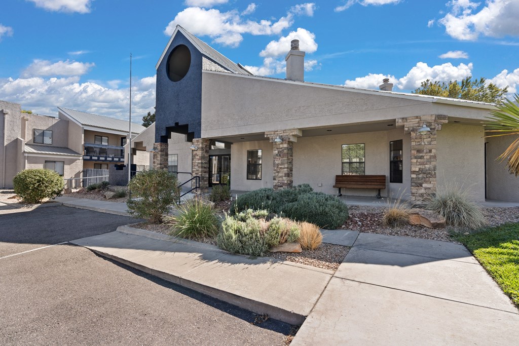 a small building with a bench in front of it