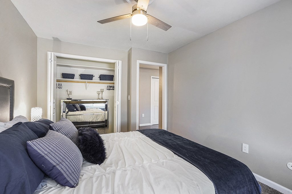 a bedroom with a bed and a ceiling fan