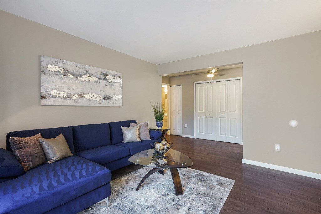 a living room with a blue couch and a coffee table