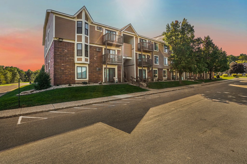 an empty street in front of an apartment building
