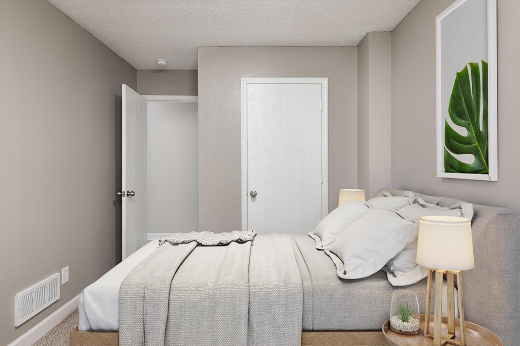 a bedroom with a large bed and a door to a closet
