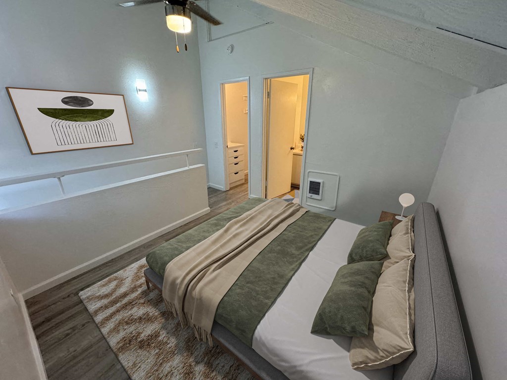 a bedroom with a bed and a door to a bathroom