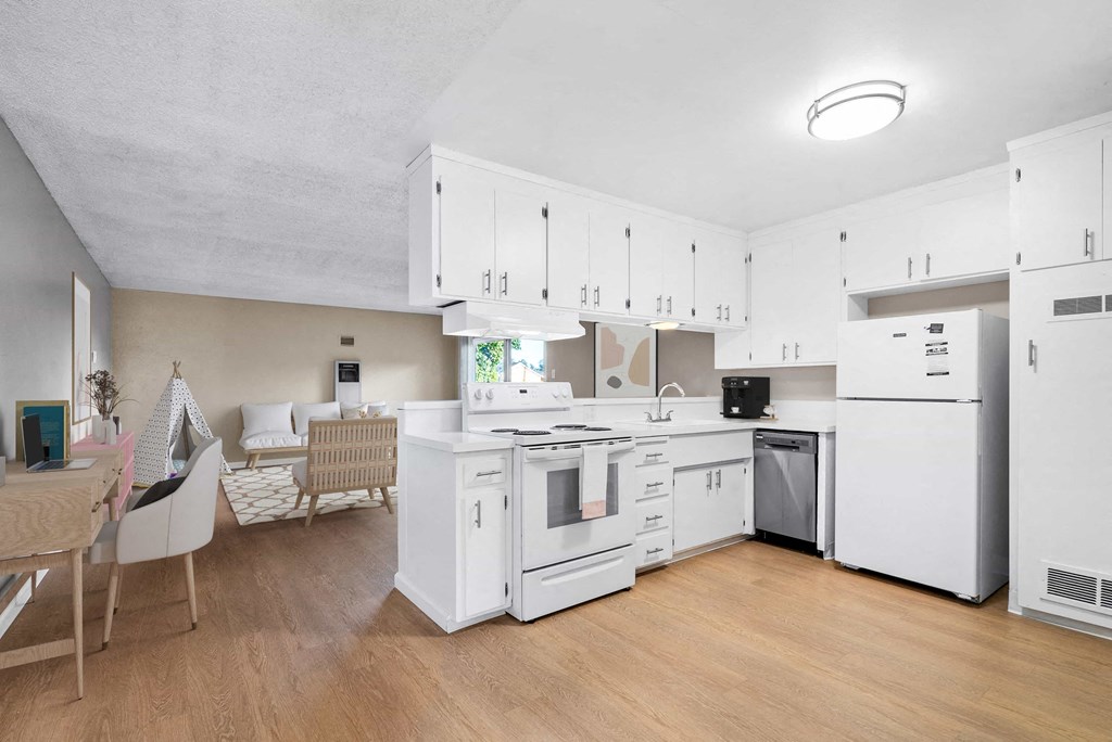a kitchen with white cabinets and appliances and a dining table