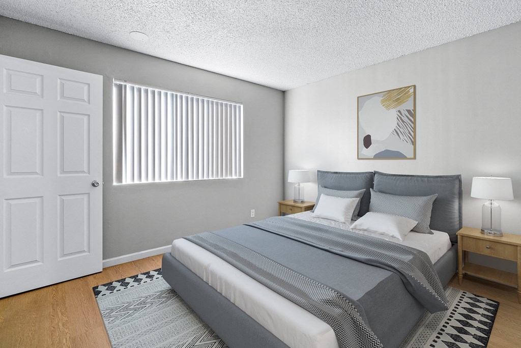 a bedroom with a large bed and a window