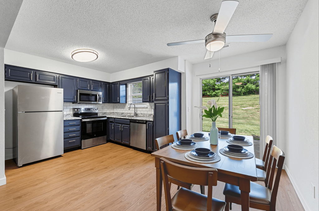 A kitchen with a dining table set for four.