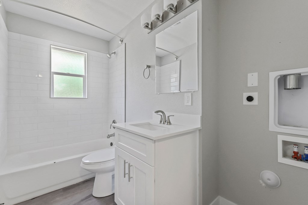 a white bathroom with a sink and a toilet