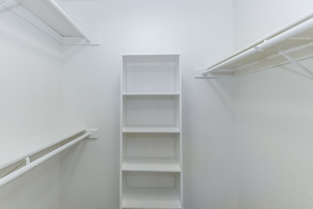 an empty closet in a room with white walls and shelves at Tides on Southern, Mesa, AZ