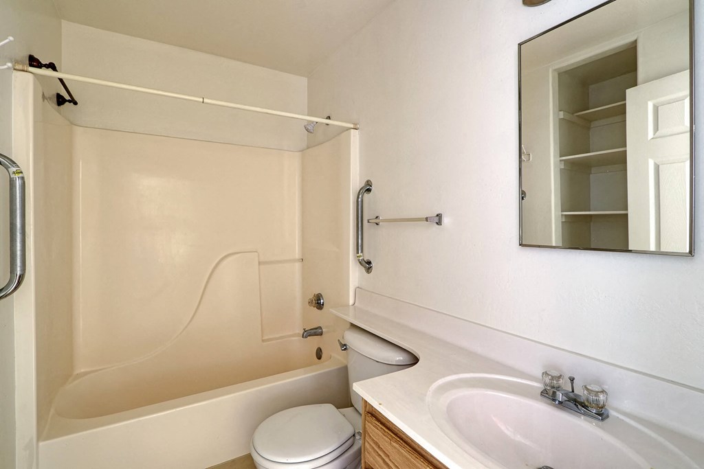 a bathroom with a sink toilet and a bath tub