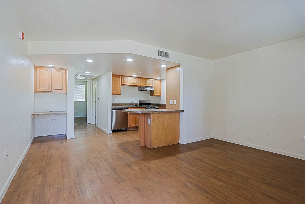 A kitchen with wooden cabinets and a countertop is visible.