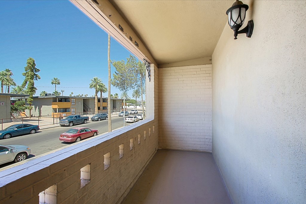 a balcony with a view of a parking lot