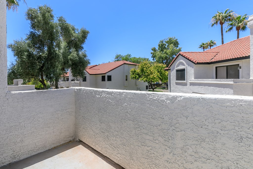 a view from the balcony of a house with a wall and a house at Tides at Mesa, Mesa, 85204