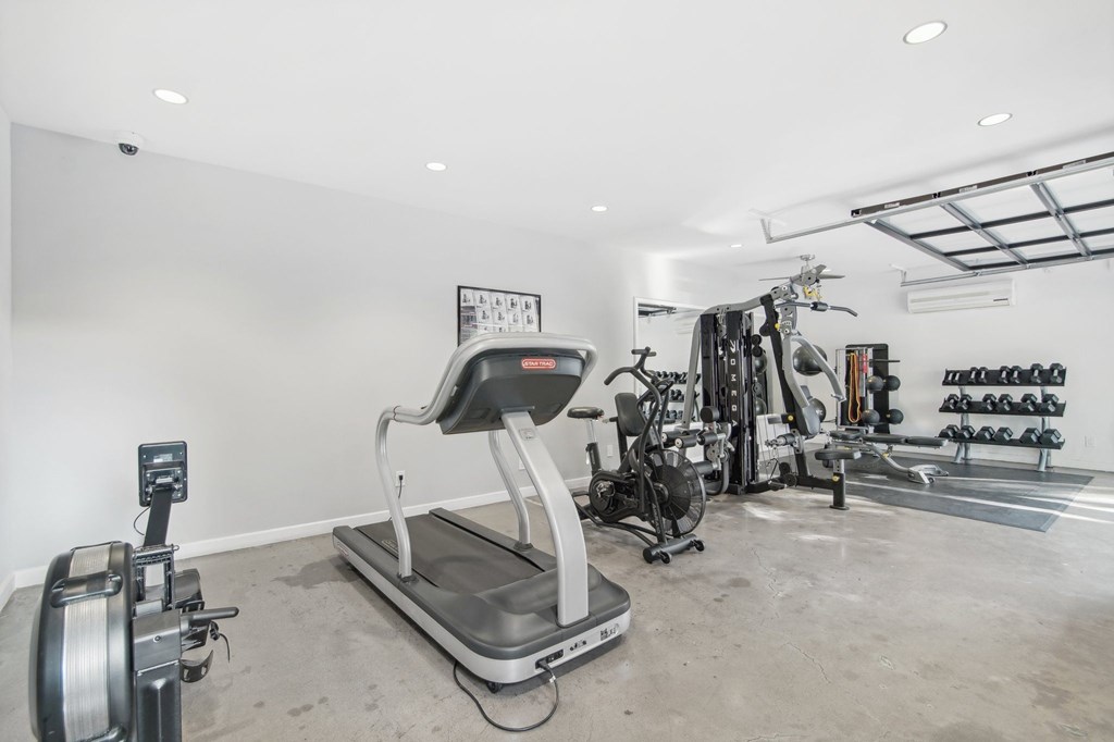 A gym with a treadmill, weights and exercise equipment. at The Viridian Apartments, Scottsdale, AZ, 85250