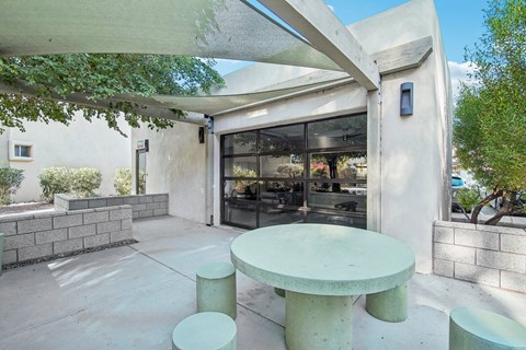 Covered patio with shade sails and seating at The Viridian Apartments, Scottsdale
