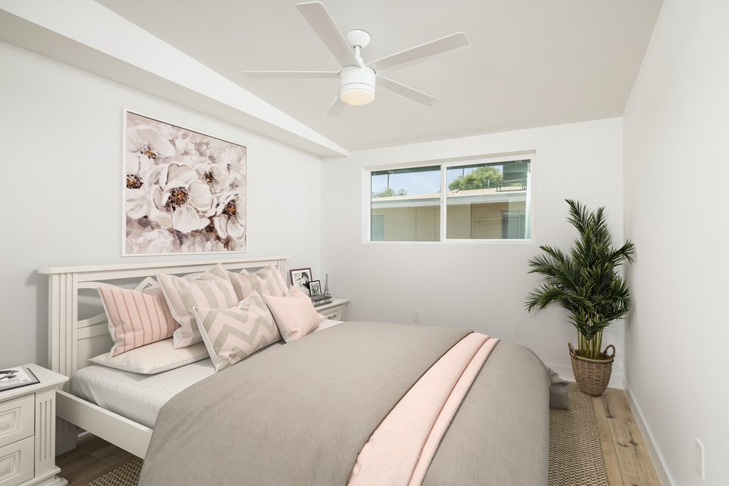 a bedroom with a bed and a ceiling fan