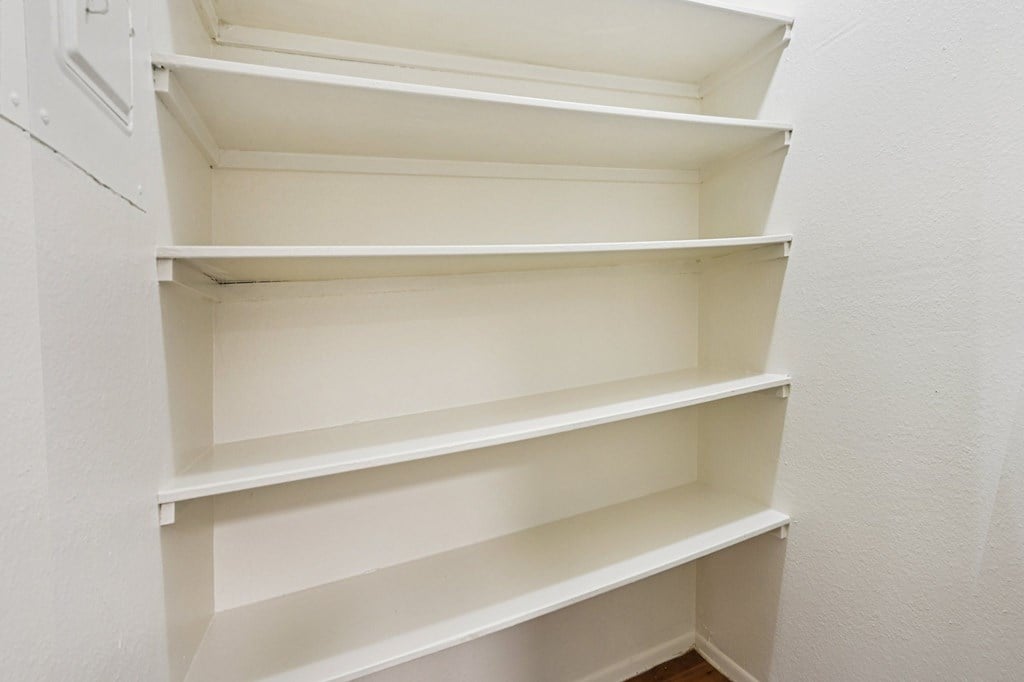 Empty white shelves in a room.