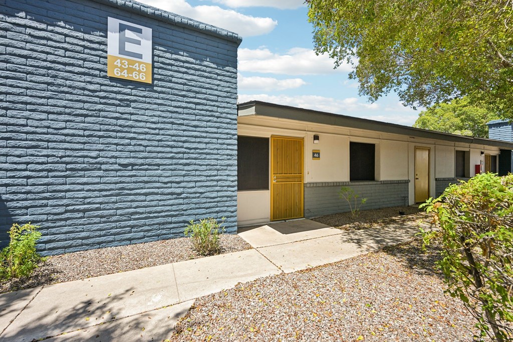 A blue building with a sign that has the numbers 43-46 and 64-66 on it.