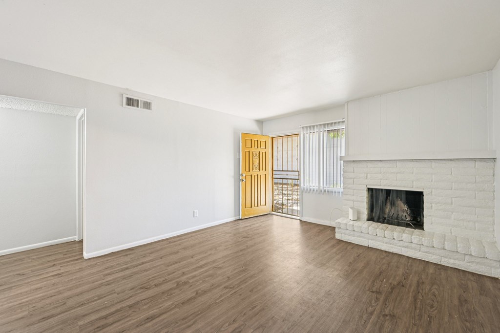 A room with a fireplace and a door.