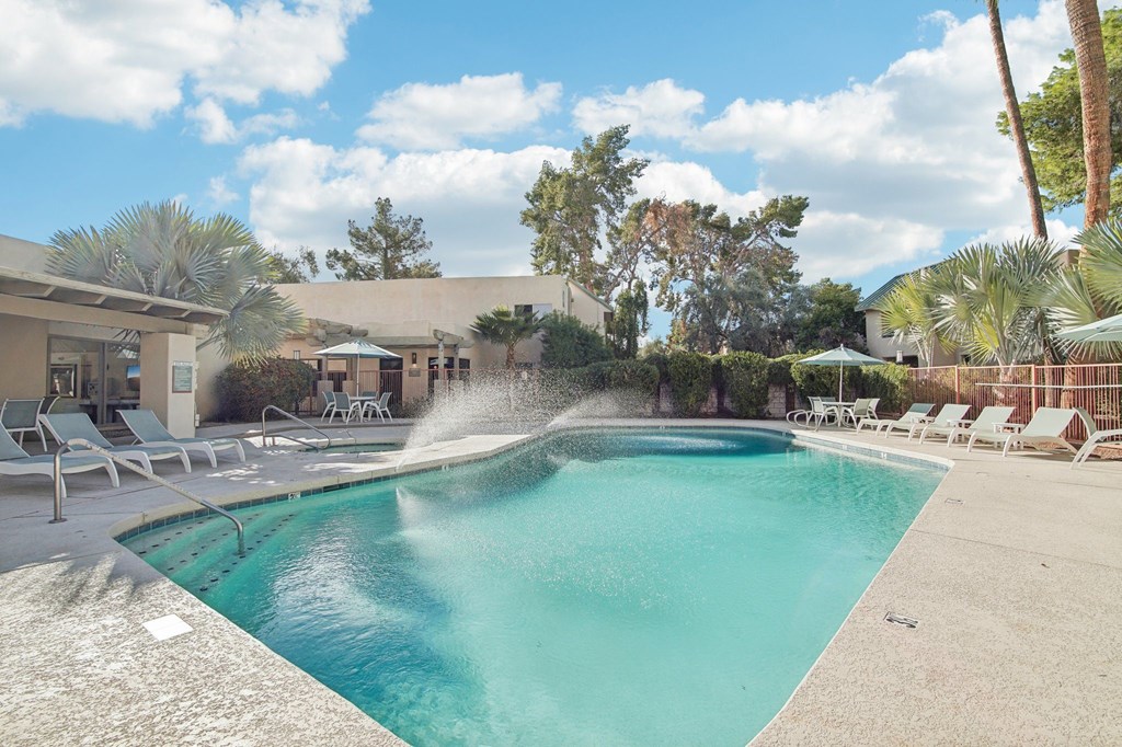 A pool with a splashing fountain in the middle of it. at The Viridian Apartments, Arizona, 85250
