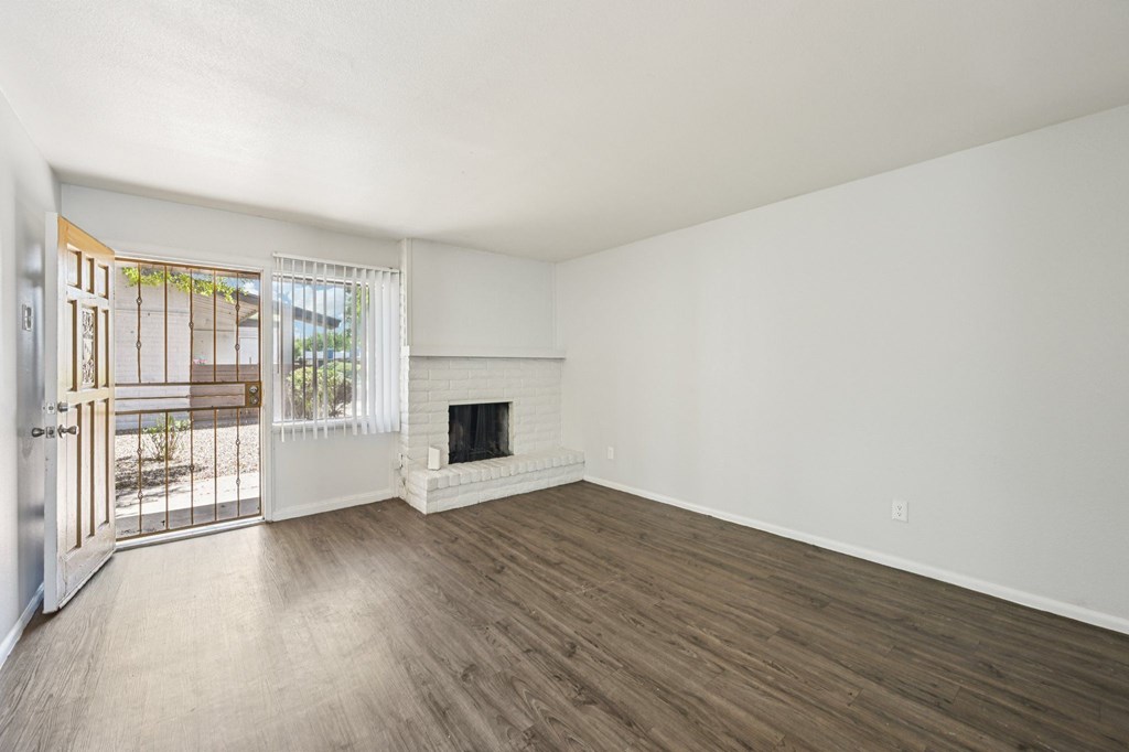 A room with a fireplace and a sliding glass door.
