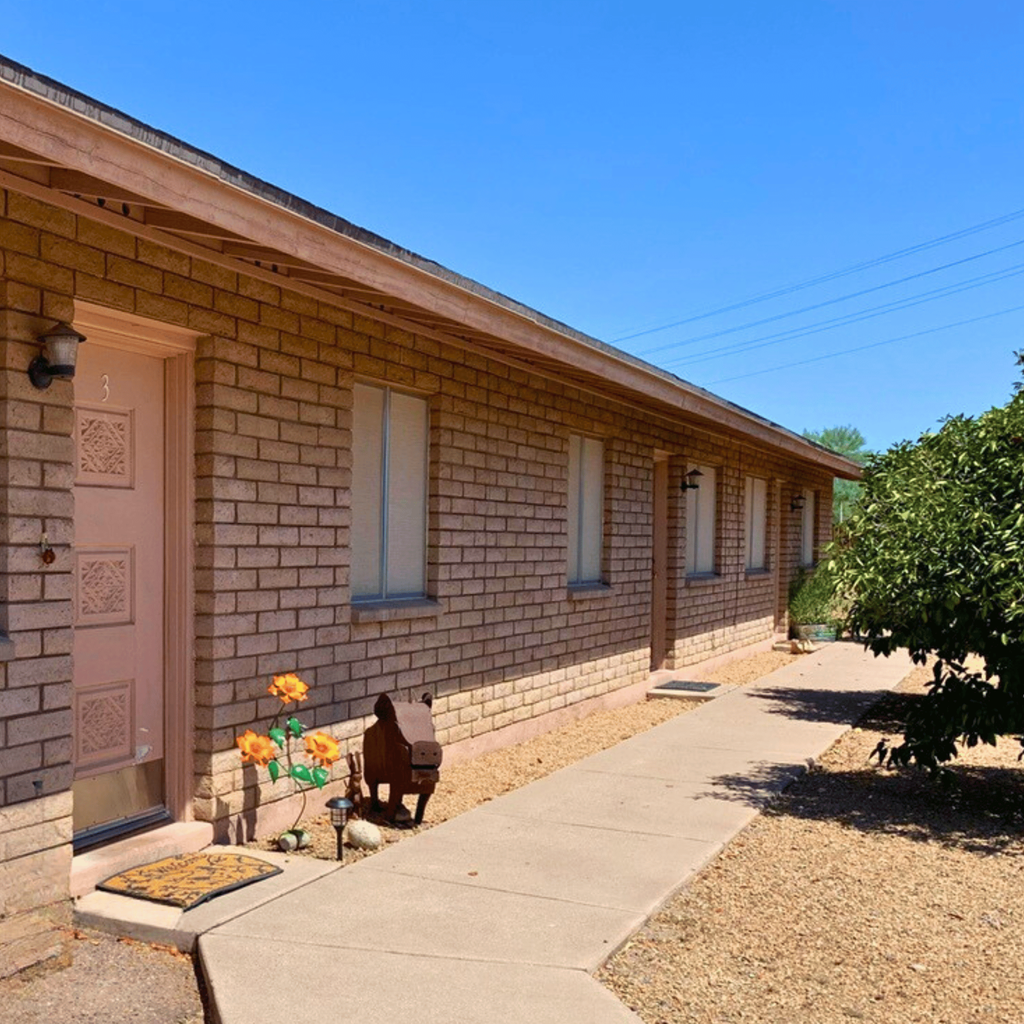 a brick building with a pink door