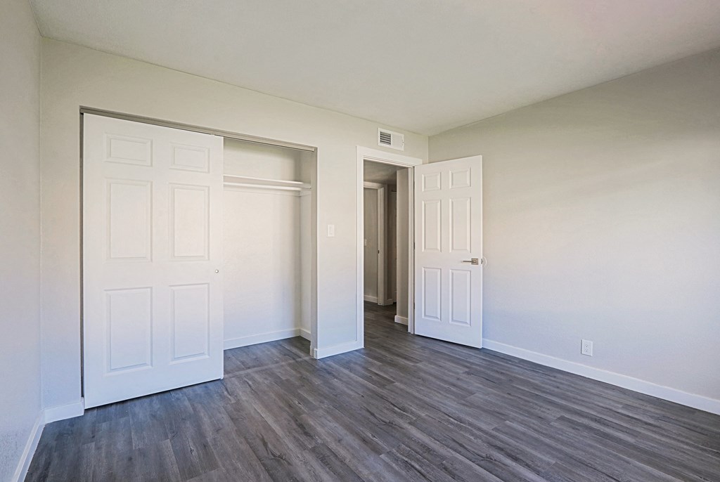 A room with a white door and a white wall.