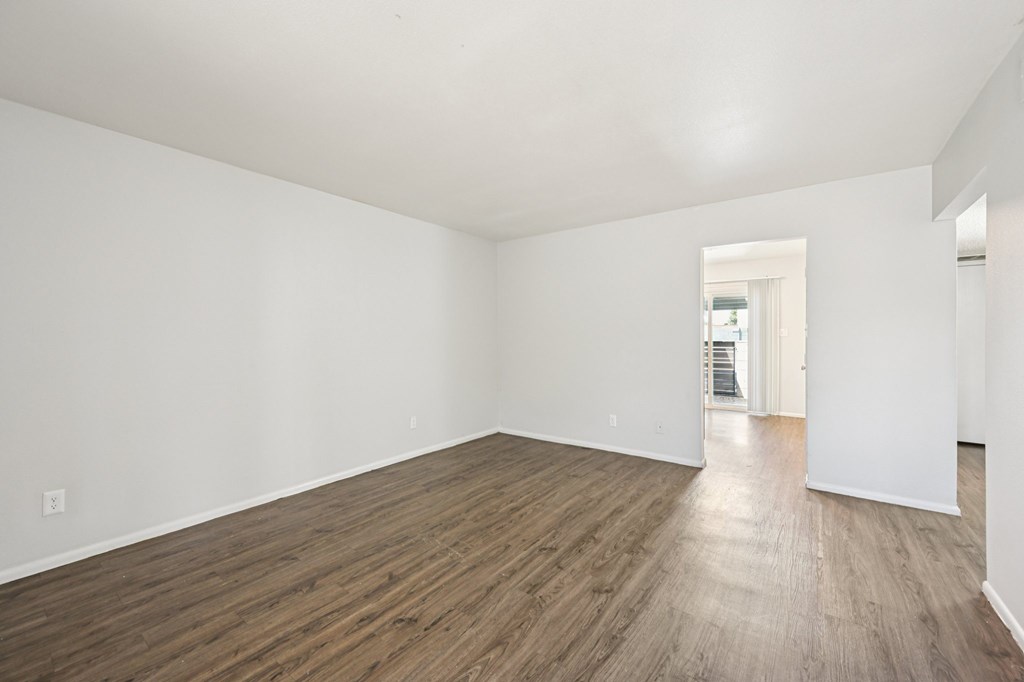 A room with wooden floors and white walls.