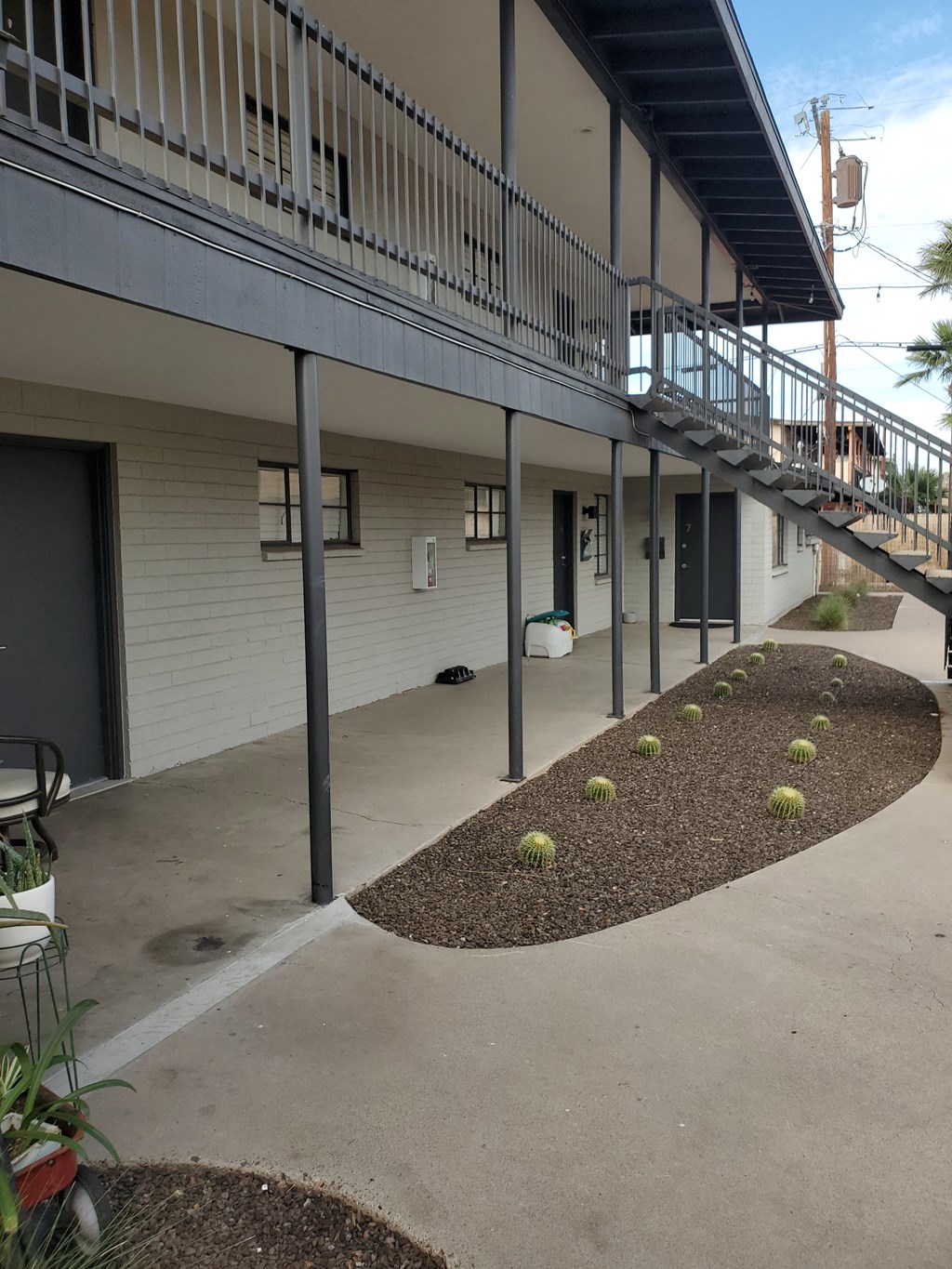 an outside view of a building with stairs and plants