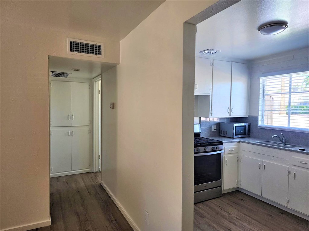 a kitchen with a stove top oven next to a window