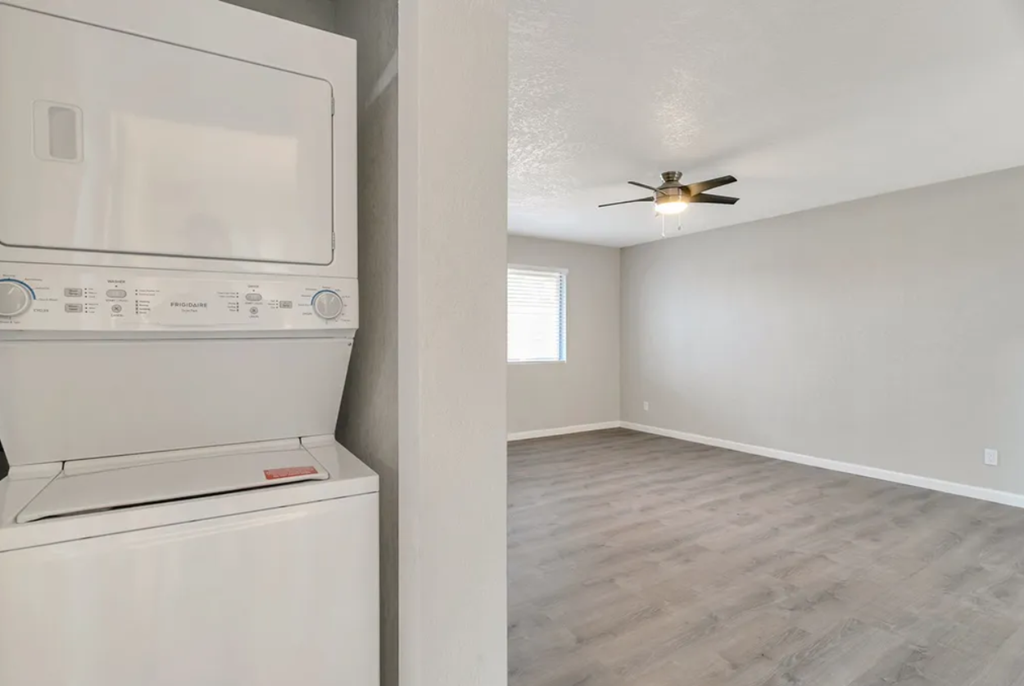 a laundry room with a washer and dryer and a ceiling fan